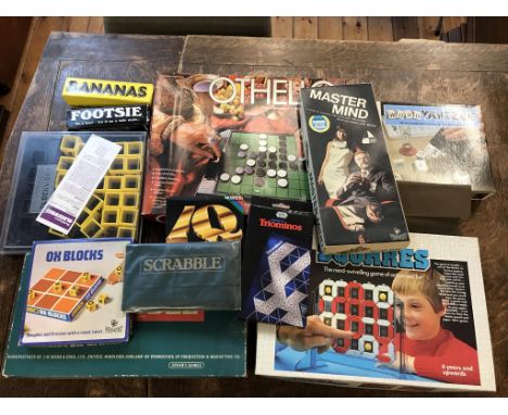 A box of board games including vintage Scrabble, Othello, Ox Blocks, Master Mind, Word Yahtzee, Squares, Blockword, Travel Sc