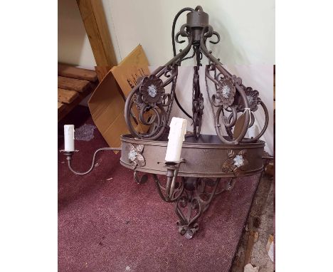 A blacksmith made wrought iron five branch five light electrolier with applied glass flowerhead decoration