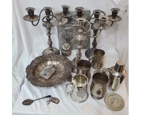 A crate containing a quantity of silver plated items including various tankards, pair of twin branch three light candelabra, 