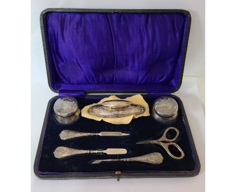A cased early 20th Century harlequin silver William Hutton &amp; Sons manicure set - mostly Birmingham 1916, one pot 1915 and