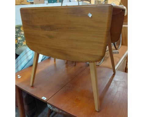 A 74cm Ercol light elm drop-leaf table, set on chamfered tapered legs