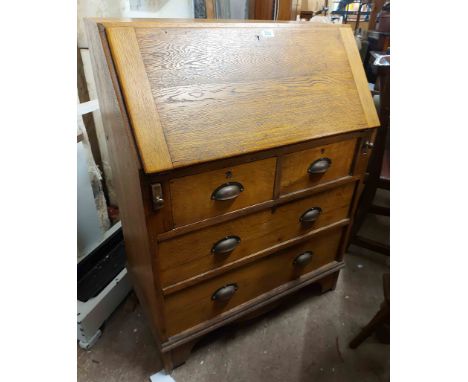 A 76cm 20th Century light oak bureau with pigeonhole interior, two short and two long graduated drawers, set on bracket feet