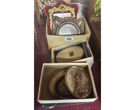 Three small boxes containing old portrait photographs in decorative frames