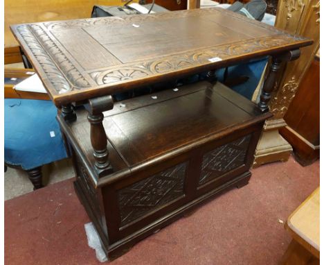 A 92cm 20th Century stained and carved oak monk's bench with metamorphic top and locker seat