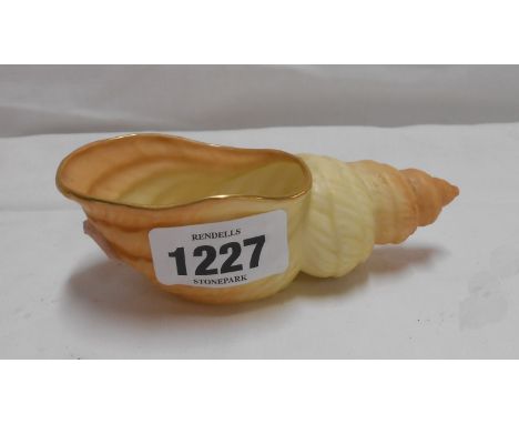 A small Royal Worcester porcelain shell form posy vase with blush ivory finish