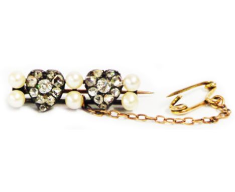 An antique rose metal double bar brooch, set with six seed pearls interspersed with two old cut diamond encrusted heart shape