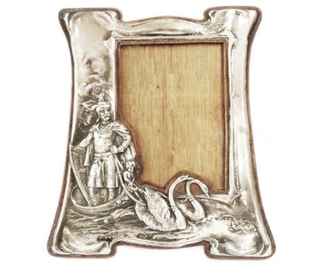 An Art Nouveau silver fronted photograph frame by Solomon Blanckensee &amp; Sons Ltd., with embossed decoration depicting Loh