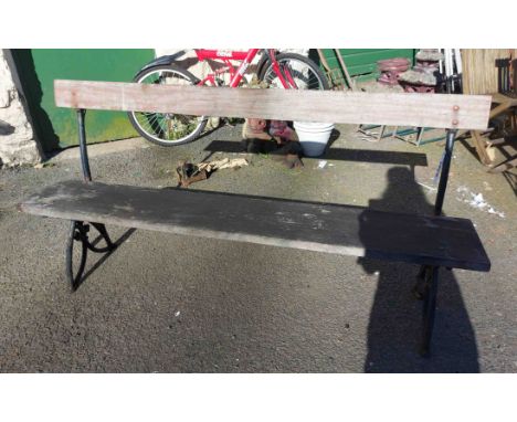 A Victorian platform style bench set on ornate cast iron supports