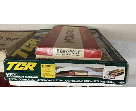 A boxed TCR two truck racing system and a Monopoly game