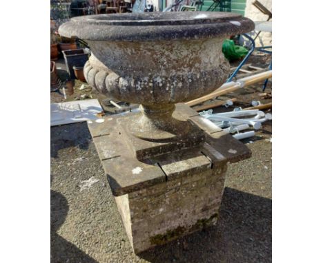 A large marble planter of classical form, set on square base