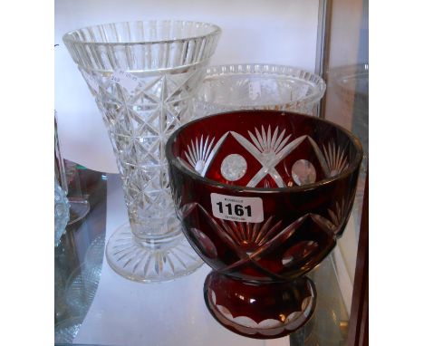 An early 20th Century cut glass vase with heavy intaglio cut frieze depicting fruit and foliage - sold with a similar cut gla