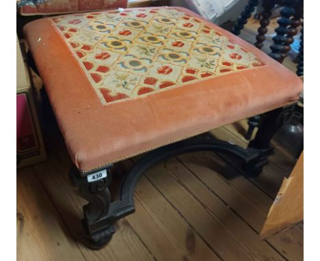 A late Victorian ebonised framed dressing stool with tapestry upholstered top, set on cabriole supports with Baroque stretche