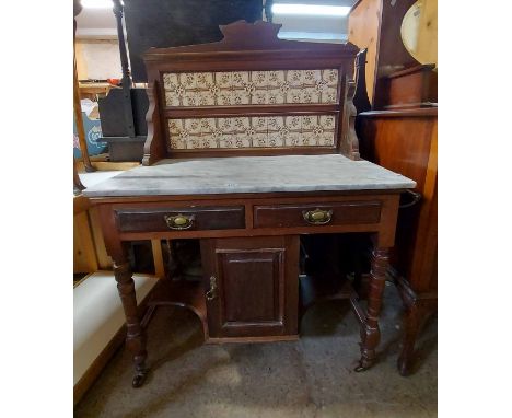A 92cm Edwardian walnut washstand with tile inset splashback and white marble top, two short drawers and single panelled cupb