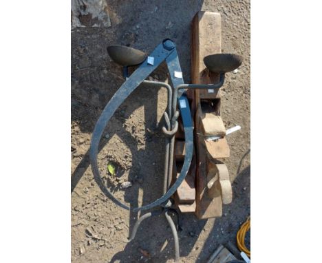 A large antique barrel screw, three wooden planes and a cast iron candlestick