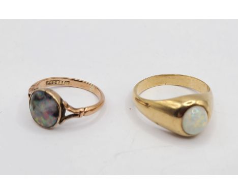 A marked 9ct yellow metal ring, set with milky opal cabochon - sold with another, set with a damaged opal panel - sizes U and