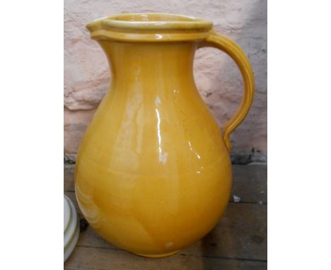 A large C.H. Brannam jug with yellow glaze finish and impressed 'Barum' mark