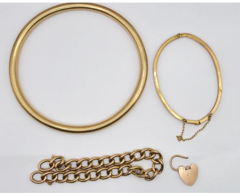 Four pieces of yellow metal jewellery comprising a marked 9ct large hollow bangle and heart shaped padlock, unmarked part ker
