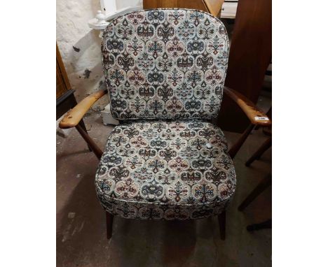 An Ercol dark elm framed hoop stick back three piece suite comprising a 1.3m two seater settee and two armchairs, all set on 