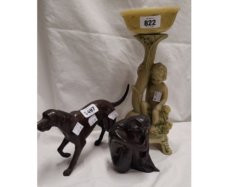 A bronze figure depicting a dog - sold with another similar depicting a lady and a green resin cherub pattern candlestick