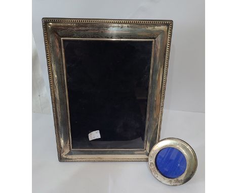 A silver fronted photograph frame with beaded border and polished wood easel back, by Carrs - to take 20cm X 15cm - sold with