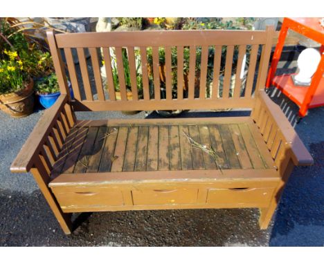 A painted wood garden storage bench with drawers under