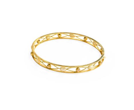 A Cultured Pearl Bangle, two plain polished rows spaced by oval openwork decoration with a plain polished bead centrally, int