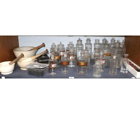 Various Clear Glass Apothecary Bottles, three pestle and mortar, etc (one shelf)