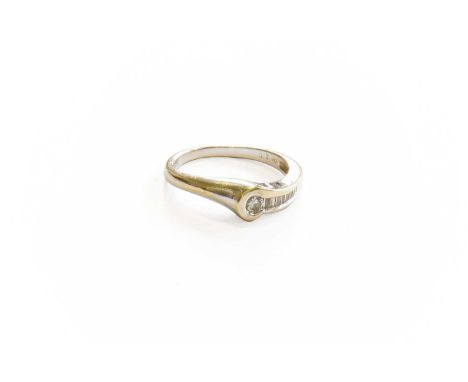 An 18 Carat White Gold Diamond Ring, a round brilliant cut diamond to a row of baguette cut diamonds, in channel settings, to