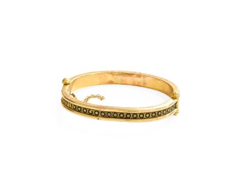 A Hinged Bangle, a band of foliate motifs sat between polished borders, inner measurements 6.2cm by 5.5cmUnmarked, in our opi