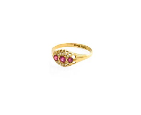 An 18 Carat Gold Ruby and Diamond Ring, three oval cut rubies flanked by curved rows of rose cut diamonds, in yellow claw set