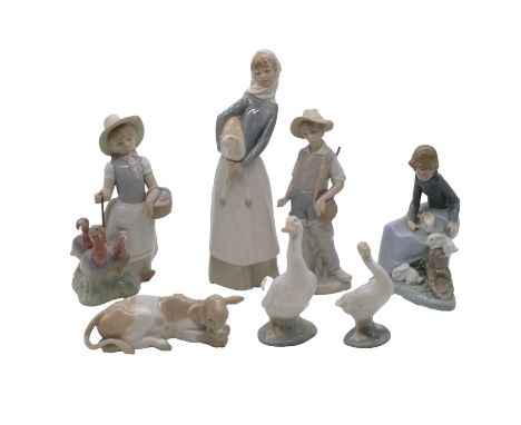 Tall Lladro figure, girl with a sheep, 28cm, and six other Lladro and Nao porcelain figures.Qty: 7