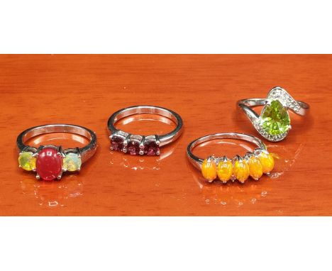 Four 925 silver and gem stone rings includes orange opalescent stone set ring. 