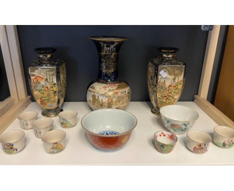 A Shelf of Japanese wares to include Satsuma panel painted vase, a pair of satsuma vases, Ornate dish with blue and white int