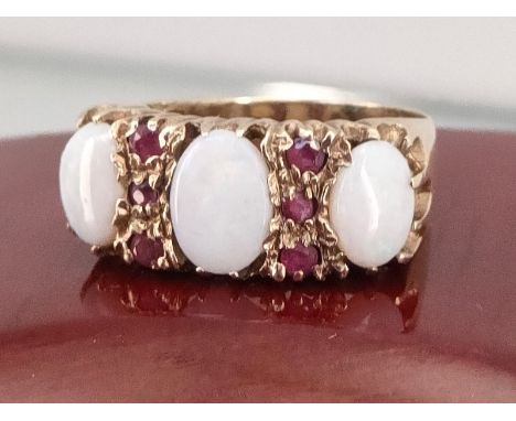 9ct yellow gold ladies ring set with three oval opal stones with Ruby stones fitted between. [Ring size N] [4.02Grams] 