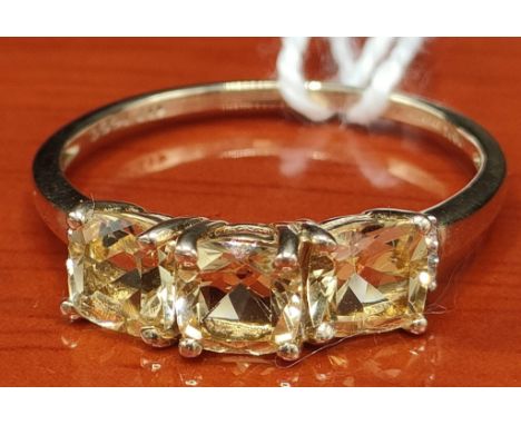 10ct yellow gold ring set with four cushion cut pale yellow spinel stones off set by diamond shoulders. [Ring size P] [1.84Gr