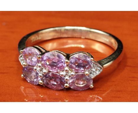 10ct yellow gold ring set with 6 purple topaz stones set with white spinel stones. [Ring size P] [2.70Grams] 