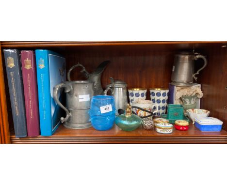 A Shelf of collectables includes pewter tankards, trinket boxes and rolls royce books 