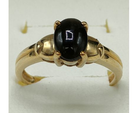 9ct yellow gold ring set with a cabochon cut black star diopside stone. [Ring size N] [2.74Grams] 