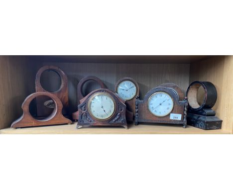 A Shelf of antique wooden clock cases and mantel clocks. 