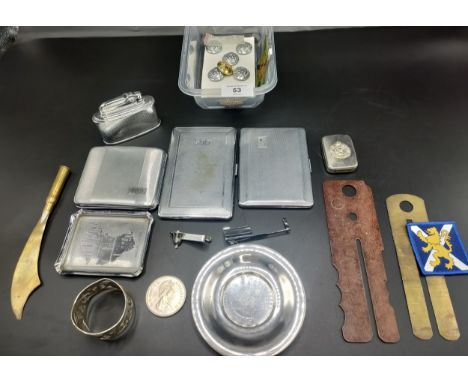 A box of military items to include trench art items, The Cameronians vesta case and military uniform button polishers togethe