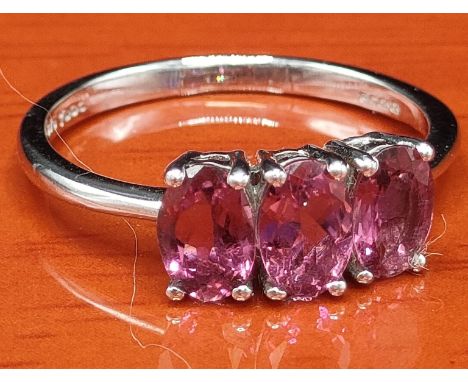 10ct white gold ring set with three purple gem stones. [Ring size M 1/2] [1.92Grams] 