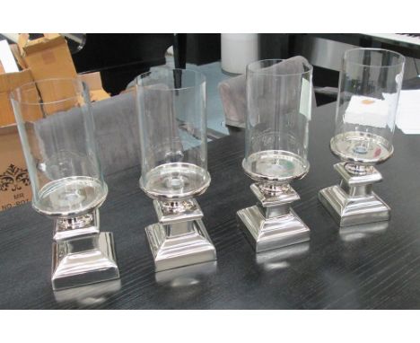 TABLE CANDLE LIGHTS, a set of four, removable glass tops on plated silvered pillar bases, 37cm H x 14cm W. (4)