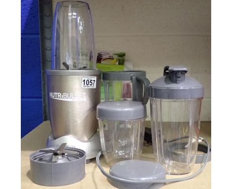 Nutri Bullet with four cups, two blender attachments and a quantity of recipe books. Not available for in-house P&P, contact 