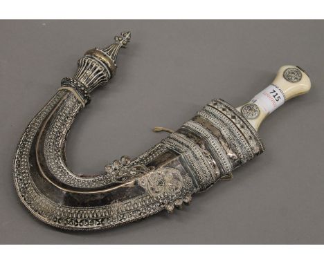 A 19th century bone handled Jambiya in an associated unmarked white metal scabbard. 30 cm high overall.