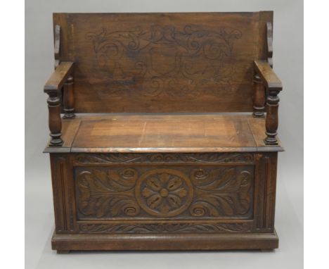 A carved oak monk's bench. 107 cm wide.