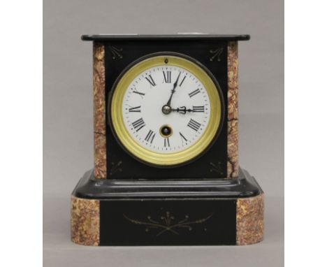 A slate and marble mantle clock. 20 cm high.