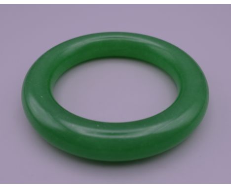 An apple green jade bangle. 5.75 cm inner diameter.