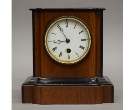 A Victorian walnut mantle clock. 20 cm high.