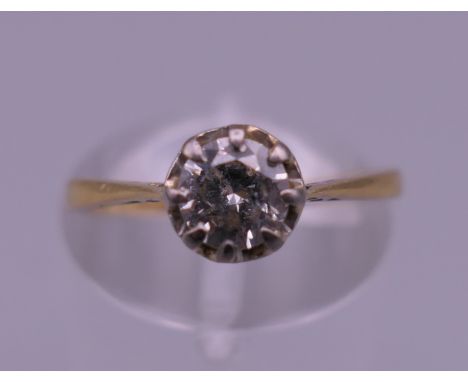 An 18 ct gold and platinum 0.50 carat diamond solitaire ring. Ring size K. 1.8 grammes total weight.