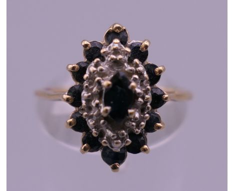 A 14 K gold diamond and sapphire ring. Ring size M/N. 2.8 grammes total weight.